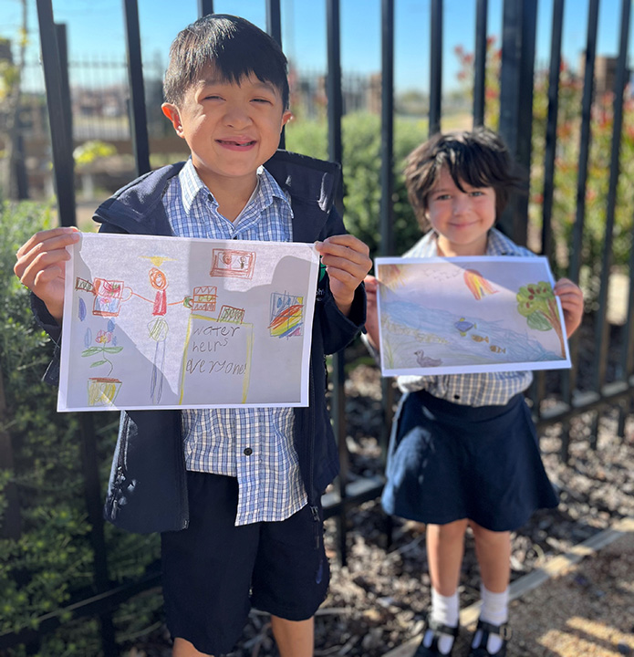 Students Xavier (front) & Alex (foreground) from St Josephs Primary School with their wonderful winning poster entries.