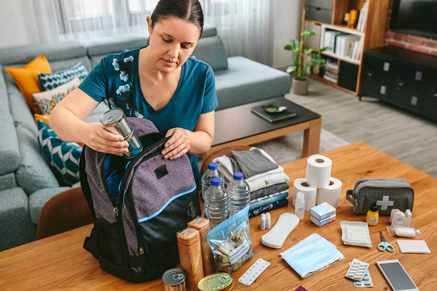 A person packing a Fire Ready Kit with items to be used to stay safe in case of a bushfire