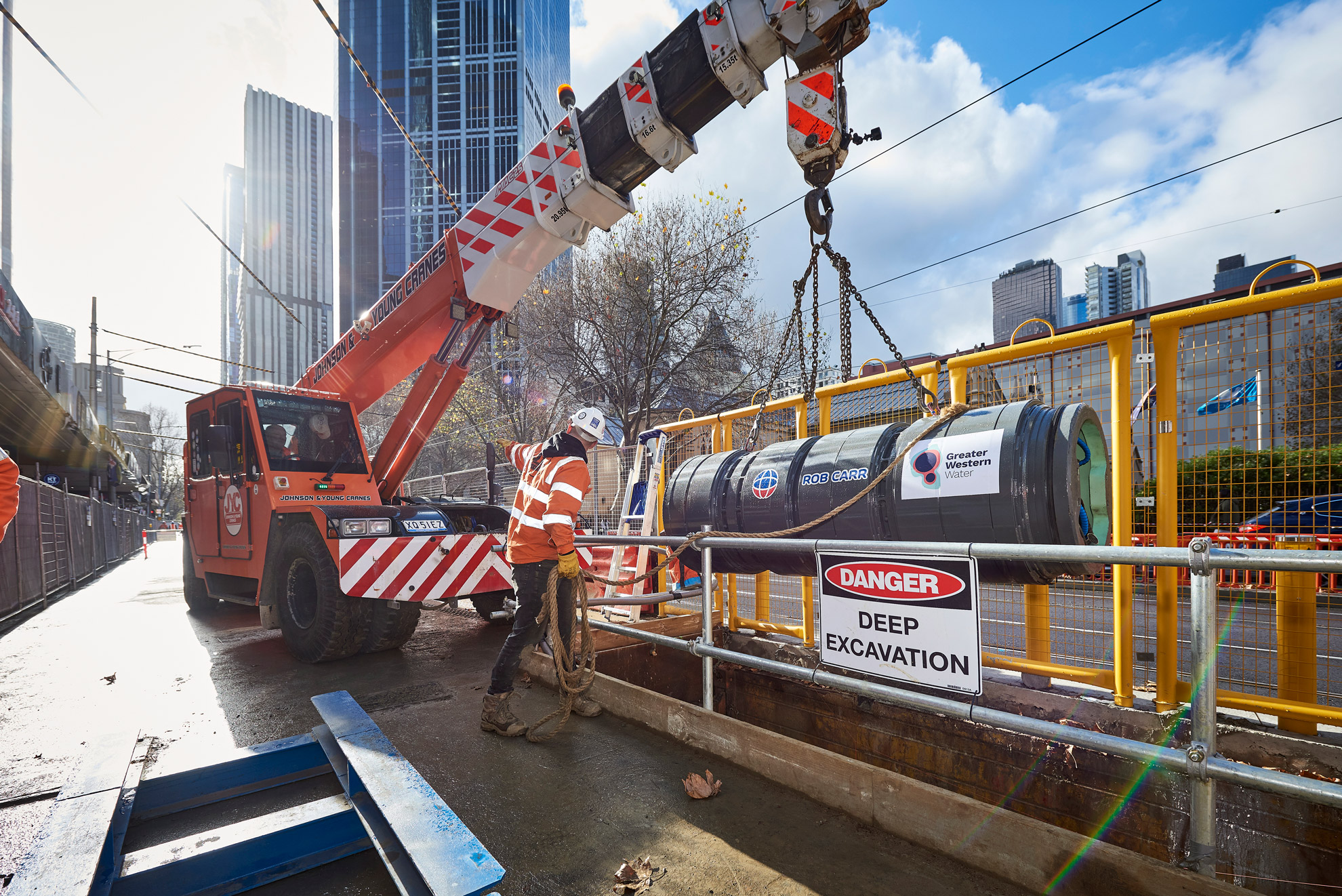 A small boring machine is loaded from a truck in to the ground