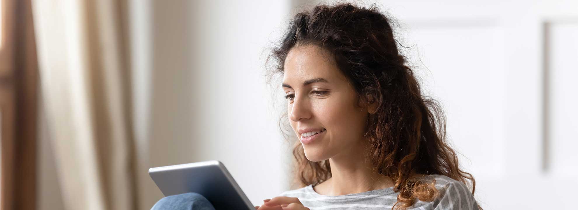 A person looking at a tablet computer.