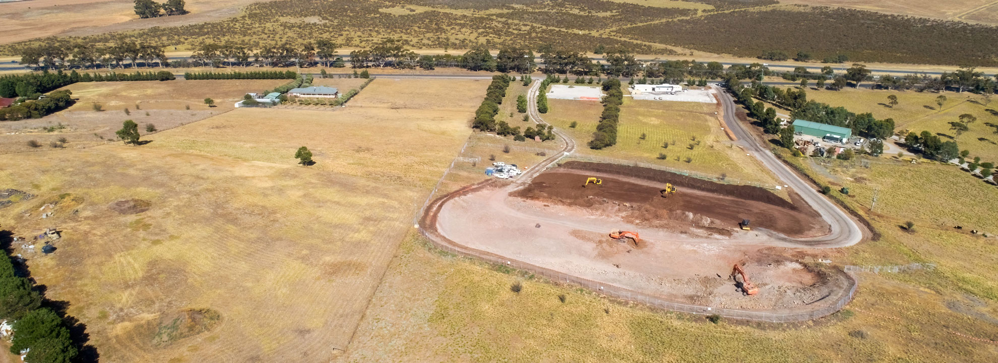 An aerial view of the Bald Hill tank site showing a earth digger moving soil and rocks.