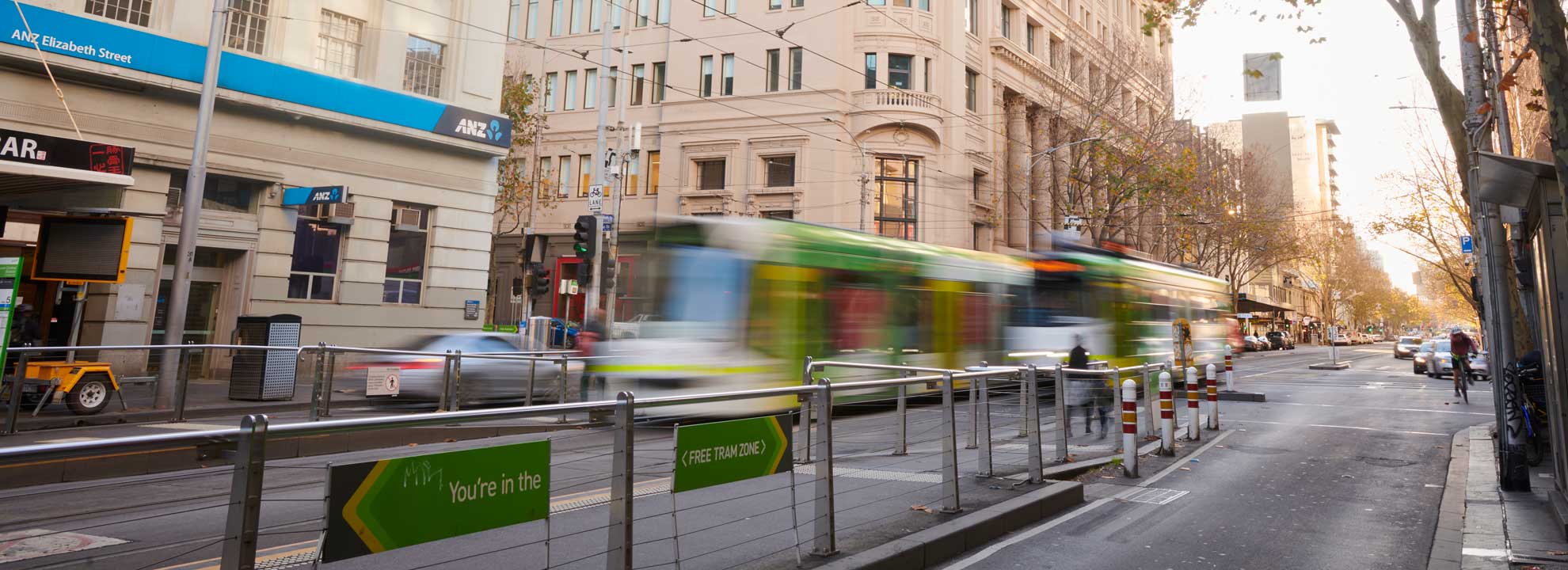 A fast-moving tram makes its way down Elizabeth Street, Melbourne