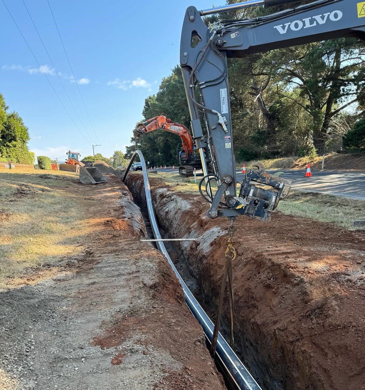 A new sewer pipe being laid with construction machines